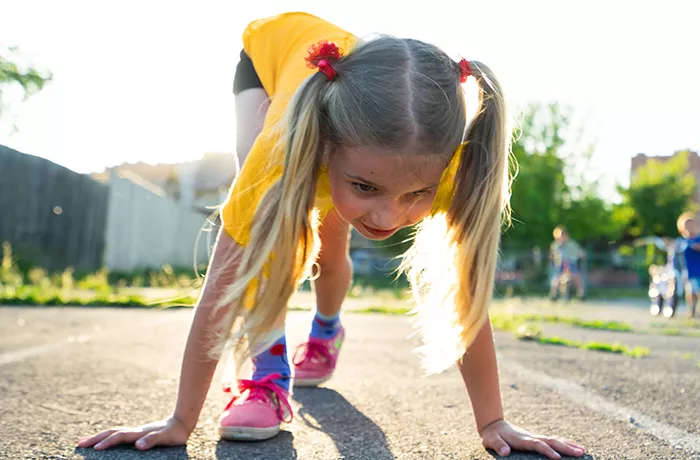 Young girl about to start a running race