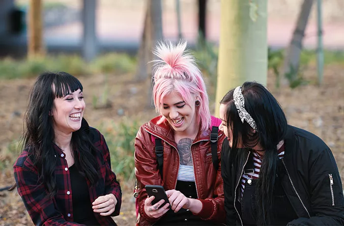 Group of young females on a phone