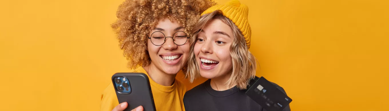 Happy and smiling women holding phone