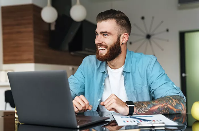 young man sitting at a laptop