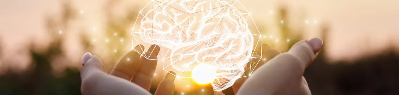 Holding an image of a brain made of lights