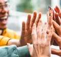 Group of people giving each other a high five
